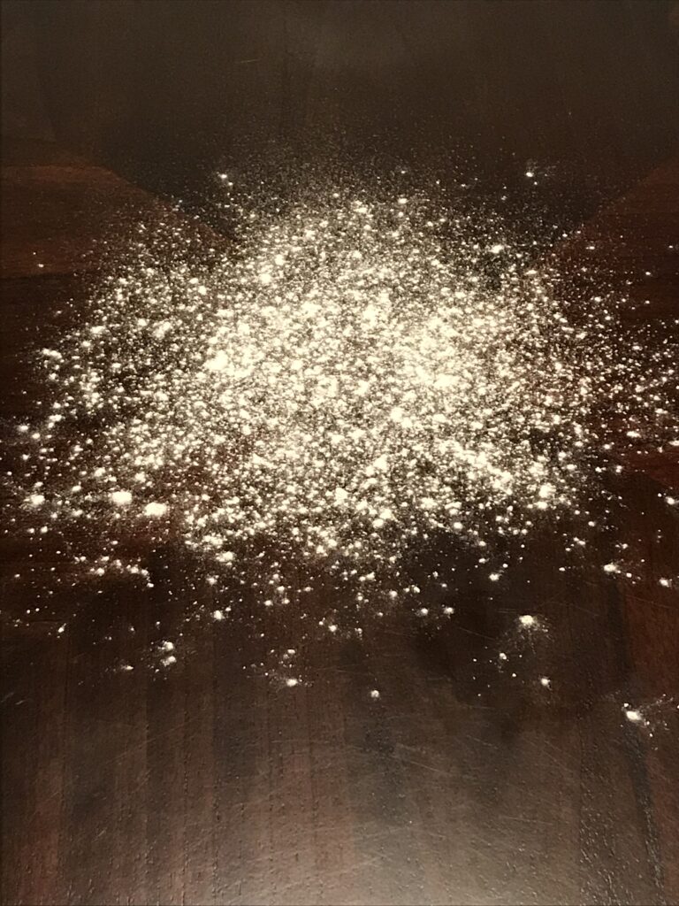 Fake snow made from flour, lightly sprinkled on a table.